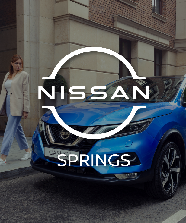 Blue Nissan Qashqai parked on a city street with a woman walking nearby; white 'NISSAN' logo with 'SPRINGS' overlayed on the car.