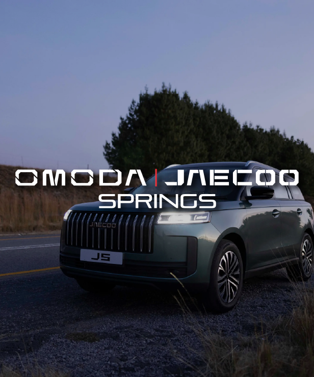 Green SUV parked on a rural road at dusk with bold white branding text across the center of the image.